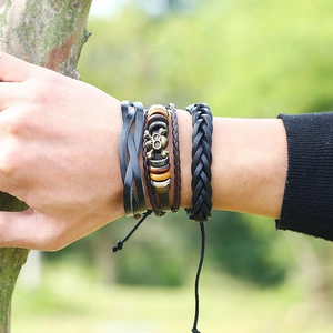 Retro multi-layer woven leather bracelet set with skull charms worn in nature