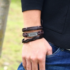 Men's retro braided dark brown leather bracelet set with a silver feather metal charm