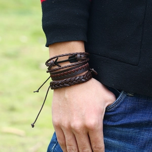 Men's vintage layered leather bracelet set featuring braided bands and arrow pendant