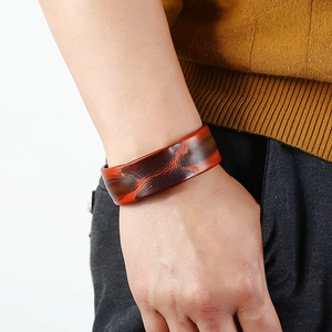 Vintage red-brown wide leather bracelet for men featuring retro dyed texture on wrist