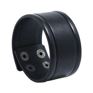 Detail view of black vintage leather punk bracelet with silver snap buttons and wide band