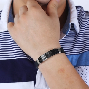 Men's black silicone bracelet featuring a Greek key pattern on a metal plaque
