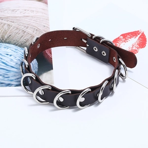 Detail of dark brown leather choker with silver D-rings and adjustable buckle