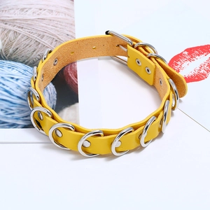 Detail of bright yellow PU leather choker with silver D-rings and adjustable buckle