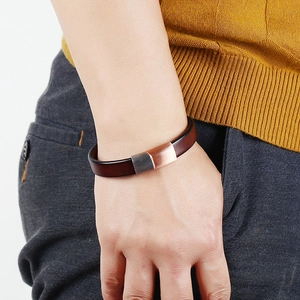 Men's leather bracelet with rose gold and gunmetal magnetic buckle worn on wrist
