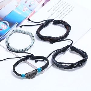 Retro punk set of four leather and beaded bracelets featuring a metal leaf pendant and weave