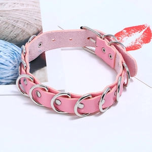 Detailed view of pink leather choker featuring silver metal rings and adjustable buckle strap