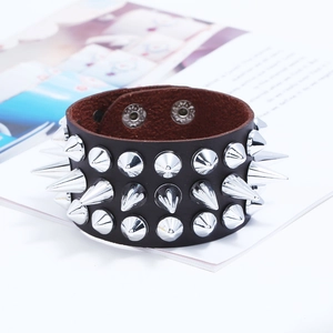 Macro shot of punk leather bracelet with triple rows of sharp silver metal spikes