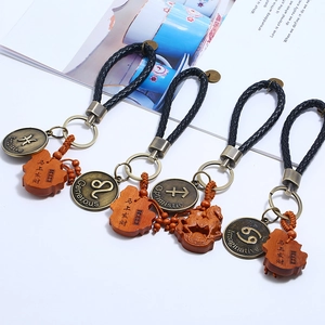 Braided leather zodiac keychain with wooden horse charm and bronze metal hardware