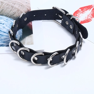 Detail of black leather punk choker featuring multiple silver metal D-rings and buckle