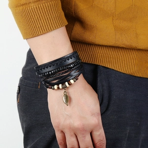 Men's vintage layered leather bracelet set with woven ropes and a bronze leaf charm