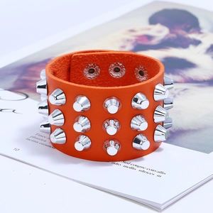 Punk orange leather bracelet featuring triple rows of silver spikes and metal snap buttons