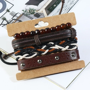 Vintage 4-piece men's leather bracelet set with punk metal studs on display card