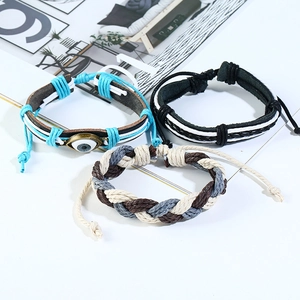 Three-piece set of woven leather bracelets featuring devil's eye charms in bohemian style