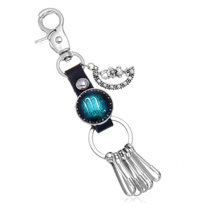 Detail view of Scorpio leather keychain with silver moon pendant and metal hooks