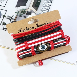 Three-piece layered leather braid bracelet set with Evil Eye charm on card display