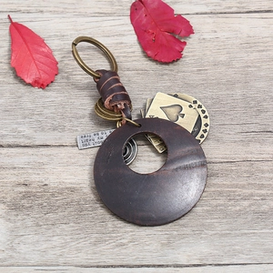 Vintage punk woven leather keychain with bronze metal ring and wooden heart charms