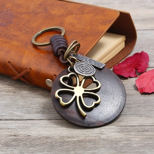 Vintage braided leather keychain with bronze clover pendant and engraved metal plate