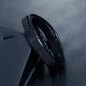Detail of multi-layer black braided leather bracelet with polished magnetic clasp
