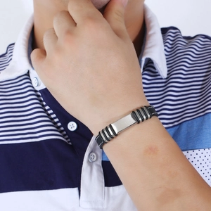 Men's stainless steel and black silicone bracelet with white stitching on wrist