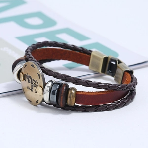 Detail of hand-woven leather Virgo zodiac bracelet with bronze charm and beads