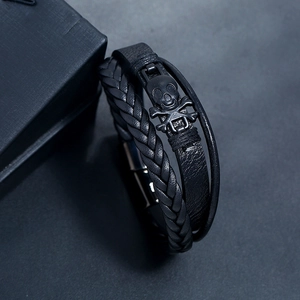 Black multilayer braided leather skull bracelet with a secure magnetic metal clasp