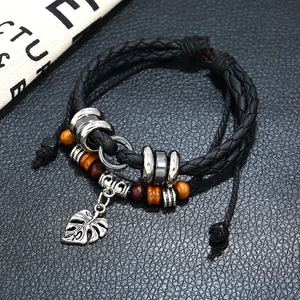 Handmade multilayer braided leather bracelet with silver leaf pendant and wooden beads