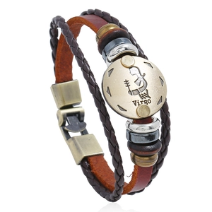 Detail of hand-woven leather bracelet featuring bronze Virgo zodiac sign charm
