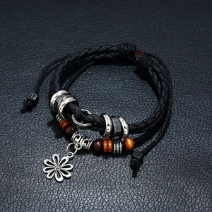 Multilayer braided black leather bracelet with silver hollow flower pendant and wood beads