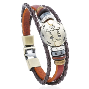 Detail view of multi-layer brown leather Libra zodiac bracelet with beads and metal charm