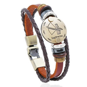 Detail of hand-woven leather Sagittarius bracelet with bronze charms and wooden beads