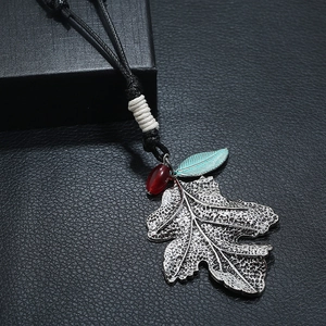 Retro long sweater necklace with vintage silver leaf pendant and red bead accents