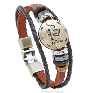 Macro view of woven leather Aquarius bracelet with bronze zodiac charm and wooden beads