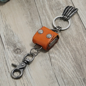 Retro orange leather keychain with silver metal lobster clasp and four key hooks on wood