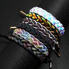 Close-up of holographic braided bracelets in six vibrant colors on a black display