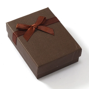 Top view of a dark brown jewelry gift box with a matching satin ribbon bow on lid