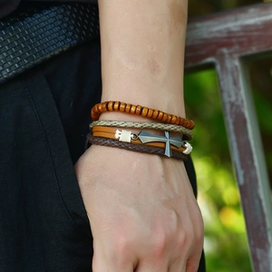 Men's multilayered leather bracelet set with wooden beads and a metal cross pendant