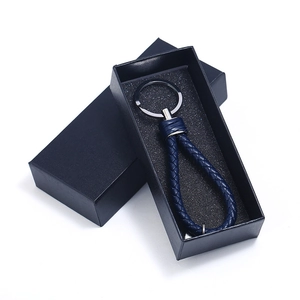 Navy blue woven leather keychain with gunmetal ring in a sleek black cardboard gift box
