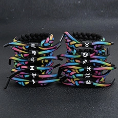 Close-up of colorful braided 12 constellation bracelets with adjustable knots and charms