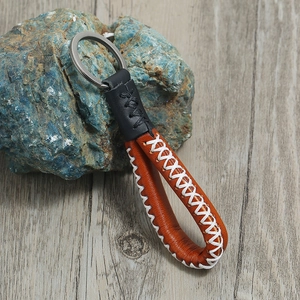 Vintage brown and black leather keychain with manual stitching and metal ring