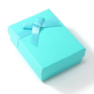 Macro view of Tiffany blue textured jewelry gift box with a satin ribbon bow