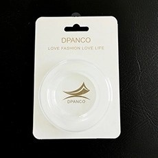 White circular phone grip accessory by DPANCO in transparent retail packaging
