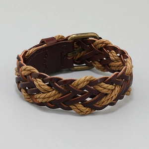 Detail of hand-woven dark brown PU leather bracelet with vintage metal clasp and rope cord