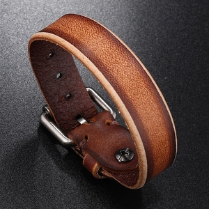 Macro shot of vintage brown leather bracelet with silver buckle and rustic texture