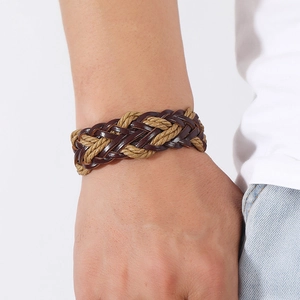Braided PU leather bracelet in dark brown and khaki fiber cord on model's wrist