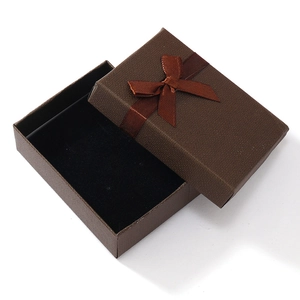 Brown textured jewelry gift box with a silk bow and black velvet lining for rings