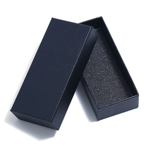 Close-up of black rectangular cardboard gift box with textured finish and foam insert
