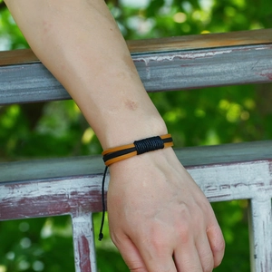 Close-up of a vintage multilayer leather bracelet with braided cords on a wrist