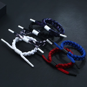 Five assorted multilayer braided cord bracelets with adjustable sliders on black leather