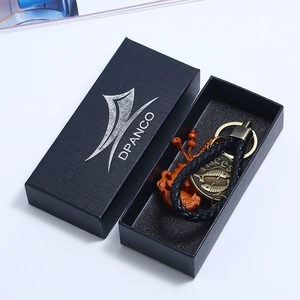 Pisces theme brass keychain with leather cord presented in a DPANCO branded gift box